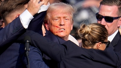 Republican presidential candidate former President Donald Trump is helped off the stage by U.S. Secret Service agents at a campaign event in Butler, Pa., on Saturday, July 13, 2024. (AP Photo/Gene J. Puskar) (AP) Republican presidential candidate former President Donald Trump is helped off the stage by U.S. Secret Service agents at a campaign event in Butler, Pa., on Saturday, July 13, 2024. (AP Photo/Gene J. Puskar) (AP)