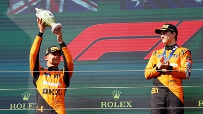 McLaren's Lando Norris celebrates with a trophy on the podium after finishing second place in the Hungarian Grand Prix (REUTERS)