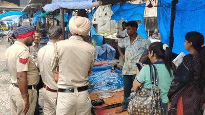 Police personnel during a raid at a fish market in Ludhiana. (HT Photo)