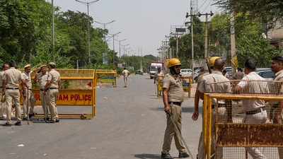 Police personnel at a check post in Sohna. (PTI Photo) Police personnel at a check post in Sohna. (PTI Photo)