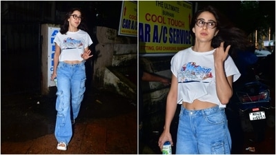 Sara Ali Khan stepped out in Mumbai wearing a casual outfit - she chose a cropped printed white tee and blue denim cargo pants. She styled the comfy look with slip-on sandals, nerdy glasses, loose tresses, and a no-makeup look. (Instagram) Sara Ali Khan stepped out in Mumbai wearing a casual outfit - she chose a cropped printed white tee and blue denim cargo pants. She styled the comfy look with slip-on sandals, nerdy glasses, loose tresses, and a no-makeup look. (Instagram)