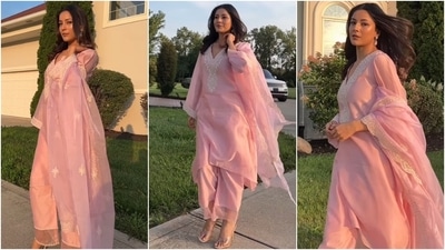 Shehnaaz Gill looks drop-dead gorgeous in a pink organza suit featuring an embroidered kurta with a relaxed fitting. She styled it with matching palazzo pants, scallop-border dupatta, jhumkis, striking glam, heels, and loose tresses. (Instagram) Shehnaaz Gill looks drop-dead gorgeous in a pink organza suit featuring an embroidered kurta with a relaxed fitting. She styled it with matching palazzo pants, scallop-border dupatta, jhumkis, striking glam, heels, and loose tresses. (Instagram)