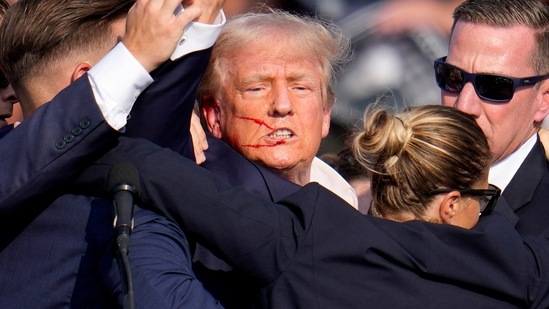 Republican presidential candidate former President Donald Trump is helped off the stage by U.S. Secret Service agents at a campaign event in Butler, Pa., on Saturday, July 13, 2024. (AP Photo/Gene J. Puskar)(AP)