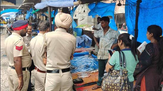 Police personnel during a raid at a fish market in Ludhiana. (HT Photo)