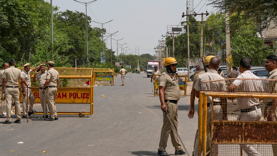 Police personnel at a check post in Sohna. (PTI Photo)