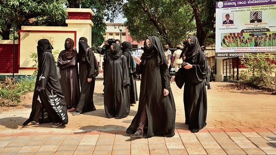 Indian Muslim students wearing burqas leave Mahatma Gandhi Memorial college after they were denied entry into the campus in Udupi, Karnataka state, India, February. 24, 2022. (AP Photo/Aijaz Rahi)