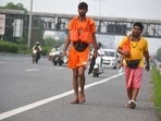 Devotees carrying holy water collected from River Ganga in Haridwar going back to their home during the Kanwar Yatra at National Highway-48 in Gurugram. (Parveen Kumar/Hindustan Times) Devotees carrying holy water collected from River Ganga in Haridwar going back to their home during the Kanwar Yatra at National Highway-48 in Gurugram. (Parveen Kumar/Hindustan Times)