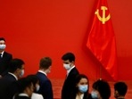 A security personnel keeps watch next to a Chinese Communist Party flag.(Reuters)