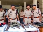 Cachar: Police personnel display the arms and ammunition recovered after an encounter with alleged Hmar terrorists, in Cachar district of Assam, Wednesday, July 17, 2024. (PTI Photo)(PTI) Cachar: Police personnel display the arms and ammunition recovered after an encounter with alleged Hmar terrorists, in Cachar district of Assam, Wednesday, July 17, 2024. (PTI Photo)(PTI)