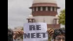 A student holds a placard demanding re-examination of NEET at the premises of the Supreme Court of India, in New Delhi on Monday. (PTI) A student holds a placard demanding re-examination of NEET at the premises of the Supreme Court of India, in New Delhi on Monday. (PTI)