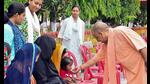 Chief minister Yogi Adityanath embraces a child during Janata Darshan at Gorakhnath Temple premises in Gorakhpur on Monday. (ANI Photo) Chief minister Yogi Adityanath embraces a child during Janata Darshan at Gorakhnath Temple premises in Gorakhpur on Monday. (ANI Photo)