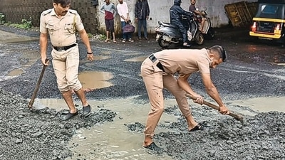 Cops fill potholes on busy Mumbai-Ahm Highway Cops fill potholes on busy Mumbai-Ahm Highway