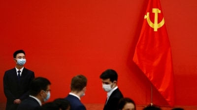 A security personnel keeps watch next to a Chinese Communist Party flag. (Reuters)