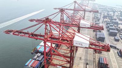 Cranes load and unload shipping containers at a port in Lianyungang, in eastern China's Jiangsu province on July 12 (AFP)