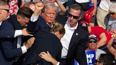 Republican candidate Donald Trump is seen with blood on his face surrounded by secret service agents as he is taken off the stage at a campaign event at Butler Farm Show Inc. in Butler, Pennsylvania, July 13, 2024. Republican candidate Donald Trump is seen with blood on his face surrounded by secret service agents as he is taken off the stage at a campaign event at Butler Farm Show Inc. in Butler, Pennsylvania, July 13, 2024.