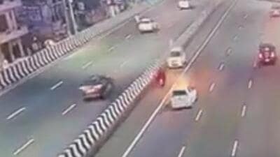 The video shows a scooter moving towards Ghaziabad in the extreme right lane while a white car is seen approaching it from the wrong side, crashing into the scooter head-on within seconds. (HT Photo) The video shows a scooter moving towards Ghaziabad in the extreme right lane while a white car is seen approaching it from the wrong side, crashing into the scooter head-on within seconds. (HT Photo)