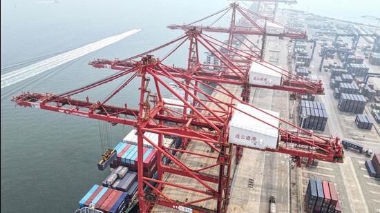 Cranes load and unload shipping containers at a port in Lianyungang, in eastern China's Jiangsu province on July 12 (AFP)