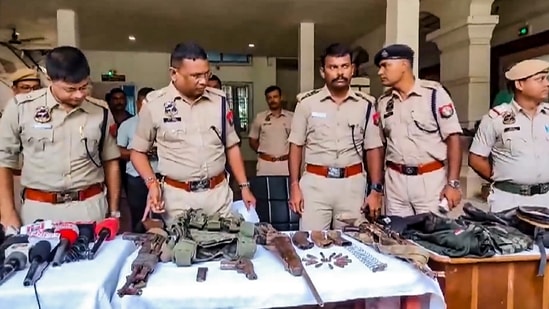 Cachar: Police personnel display the arms and ammunition recovered after an encounter with alleged Hmar terrorists, in Cachar district of Assam, Wednesday, July 17, 2024. (PTI Photo)(PTI)