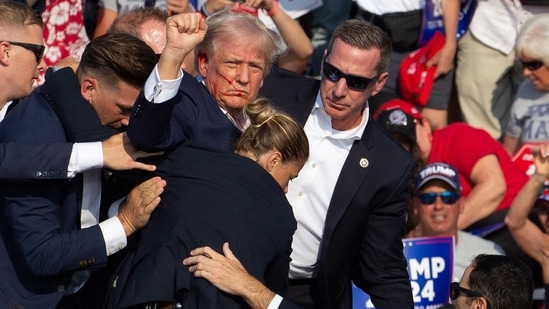 Republican candidate Donald Trump is seen with blood on his face surrounded by secret service agents as he is taken off the stage at a campaign event at Butler Farm Show Inc. in Butler, Pennsylvania, July 13, 2024.