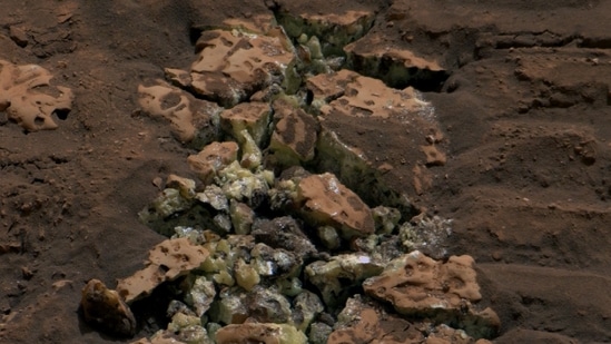 NASA's Curiosity rover found these yellow crystals after driving over rocks. When cracked open, they revealed a surprise inside. Further analysis confirmed that the crystals are elemental sulfur, making it the first time this kind of sulfur has been found on Mars. (X / @MarsCuriosity)