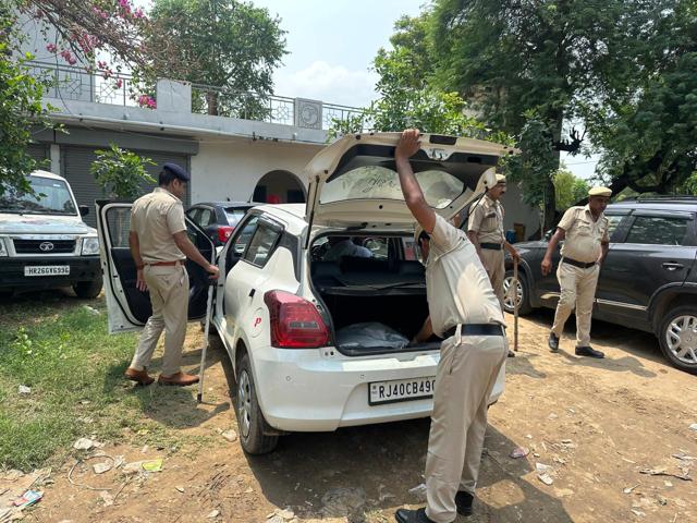 As part of their safety measures, police checking a vehicle at a check post before Nuh near Sohna in Gurugram on Monday. (HT Photo)