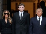 Former President Donald Trump, center right, stands with his wife Melania, second left. (AP Photo/Rebecca Blackwell) Former President Donald Trump, center right, stands with his wife Melania, second left. (AP Photo/Rebecca Blackwell)