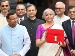 Union Finance Minister Nirmala Sitharaman showcases a red pouch carrying the Budget documents, outside the Finance Ministry in North Block