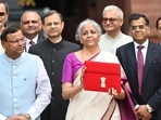  Union Finance Minister Nirmala Sitharaman showcases a red pouch carrying the Budget documents  (Photo by Arvind Yadav/ Hindustan Times)