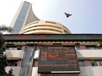 A bird flies past a screen displaying the Sensex results on the facade of the Bombay Stock Exchange (BSE) building in Mumbai. (Niharika Kulkarni/Reuters)