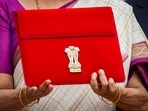 New Delhi: Union Finance Minister Nirmala Sitharaman carries a red pouch carrying the Budget documents, outside the Finance Ministry in North Block before leaving for the Parliament where she will table the Union Budget 2024-25, in New Delhi, Tuesday, July 23, 2024. (PTI Photo/Shahbaz Khan) New Delhi: Union Finance Minister Nirmala Sitharaman carries a red pouch carrying the Budget documents, outside the Finance Ministry in North Block before leaving for the Parliament where she will table the Union Budget 2024-25, in New Delhi, Tuesday, July 23, 2024. (PTI Photo/Shahbaz Khan)