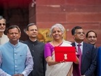 Nirmala Sitharaman displays a red pouch carrying the Budget documents outside the Finance Ministry. Nirmala Sitharaman displays a red pouch carrying the Budget documents outside the Finance Ministry.