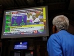 A man watches a screen displaying India's Finance Minister Nirmala Sitharaman's budget speech at a railway station in Mumbai, India, July 23, 2024.