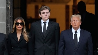 Former President Donald Trump, center right, stands with his wife Melania, second left. (AP Photo/Rebecca Blackwell) (AP) Former President Donald Trump, center right, stands with his wife Melania, second left. (AP Photo/Rebecca Blackwell) (AP)