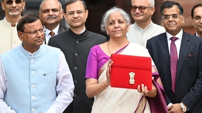 Union Finance Minister Nirmala Sitharaman showcases a red pouch carrying the Budget documents, outside the Finance Ministry in North Block (Hindustan Times) Union Finance Minister Nirmala Sitharaman showcases a red pouch carrying the Budget documents, outside the Finance Ministry in North Block (Hindustan Times)