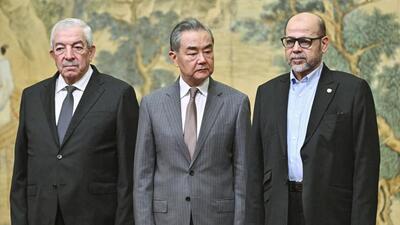 China's Foreign Minister Wang Yi, centre, hosts an event for Mahmoud al-Aloul, left, vice chairman of Fatah, and Mussa Abu Marzuk, a senior member of Hamas, to meet at the Diaoyutai State Guesthouse in Beijing, on Tuesday. (AP) China's Foreign Minister Wang Yi, centre, hosts an event for Mahmoud al-Aloul, left, vice chairman of Fatah, and Mussa Abu Marzuk, a senior member of Hamas, to meet at the Diaoyutai State Guesthouse in Beijing, on Tuesday. (AP)