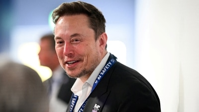 FILE PHOTO: Tesla, X (formerly known as Twitter) and SpaceX's CEO Elon Musk speaks with other delegates on Day 1 of the AI Safety Summit at Bletchley Park in Bletchley, Britain on November 1, 2023. Leon Neal/Pool via REUTERS/File Photo (via REUTERS)