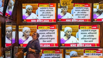 A woman watches the Union Budget 2024-25 being presented by Union finance minister Nirmala Sitharaman at a showroom in Mumbai. (PTI) A woman watches the Union Budget 2024-25 being presented by Union finance minister Nirmala Sitharaman at a showroom in Mumbai. (PTI)