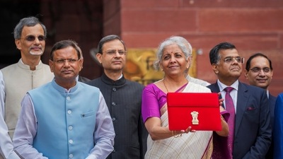 Nirmala Sitharaman displays a red pouch carrying the Budget documents outside the Finance Ministry. (PTI) Nirmala Sitharaman displays a red pouch carrying the Budget documents outside the Finance Ministry. (PTI)