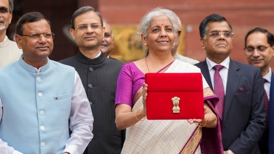 Finance minister Nirmala Sitharaman showcases a tablet wrapped in a red pouch carrying the Budget documents. (PTI)