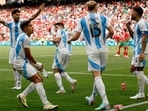  Morocco fans throw cups to Argentina players after Cristian Medina of Argentina scores their second goal which was disallowed later.