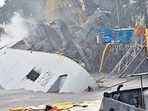 Indian Navy frigate INS Brahmaputra tilted to one side after fire damages. (ANI) Indian Navy frigate INS Brahmaputra tilted to one side after fire damages. (ANI)