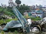 Security personnel inspect the remains of a Saurya Airlines flight after it crashed during takeoff at Tribhuvan International Airport in Kathmandu on July 24, (Photo by PRAKASH MATHEMA / AFP)(AFP) Security personnel inspect the remains of a Saurya Airlines flight after it crashed during takeoff at Tribhuvan International Airport in Kathmandu on July 24, (Photo by PRAKASH MATHEMA / AFP)(AFP)