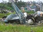 Army personnel and other officials stand around the debris of a Saurya Airlines plane after it crashed during takeoff at Tribhuvan International Airport in Kathmandu on July 24, 2024.(AFP) Army personnel and other officials stand around the debris of a Saurya Airlines plane after it crashed during takeoff at Tribhuvan International Airport in Kathmandu on July 24, 2024.(AFP)