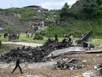 People stand at the site after a Saurya Airlines' plane crashed during takeoff at Tribhuvan International Airport in Kathmandu on July 24, 2024. (Photo by PRAKASH MATHEMA / AFP) People stand at the site after a Saurya Airlines' plane crashed during takeoff at Tribhuvan International Airport in Kathmandu on July 24, 2024. (Photo by PRAKASH MATHEMA / AFP)