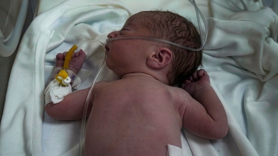 A Palestinian baby boy, not yet named, who was delivered prematurely after his mother Ola al-Kurd was killed in an Israeli strike, lies in an incubator at a hospital in Deir al-Balah(AP)