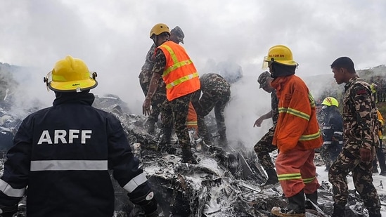 Nepal plane crash LIVE: Rescuers and army personnel stand at the site after a Saurya Airlines' plane crashed during takeoff at Tribhuvan International Airport in Kathmandu on July 24, 2024.(AFP)