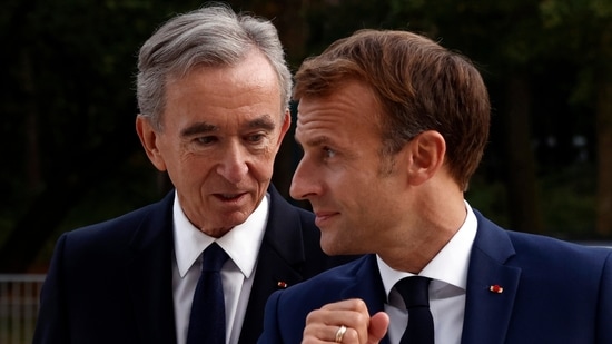 LVMH luxury group CEO Bernard Arnault, left, and French President Emmanuel Macron. (AP)