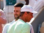 Serbia's Novak Djokovic hugs Spain's Rafael Nadal during a practice session.