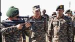 Chief of army staff General Upendra Dwivedi checks a weapon during his visit to the forward locations along the LoC. (ANI)