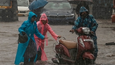Children push their father's scooter through a flooded street as it rains in Mumbai, India, Thursday, July 25, 2024. (AP Photo/Rafiq Maqbool) (AP) Children push their father's scooter through a flooded street as it rains in Mumbai, India, Thursday, July 25, 2024. (AP Photo/Rafiq Maqbool) (AP)